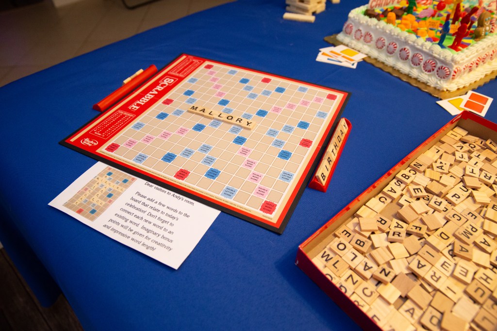 Toy Story-themed Scrabble guest activity board with the name Mallory spelled out in tiles
