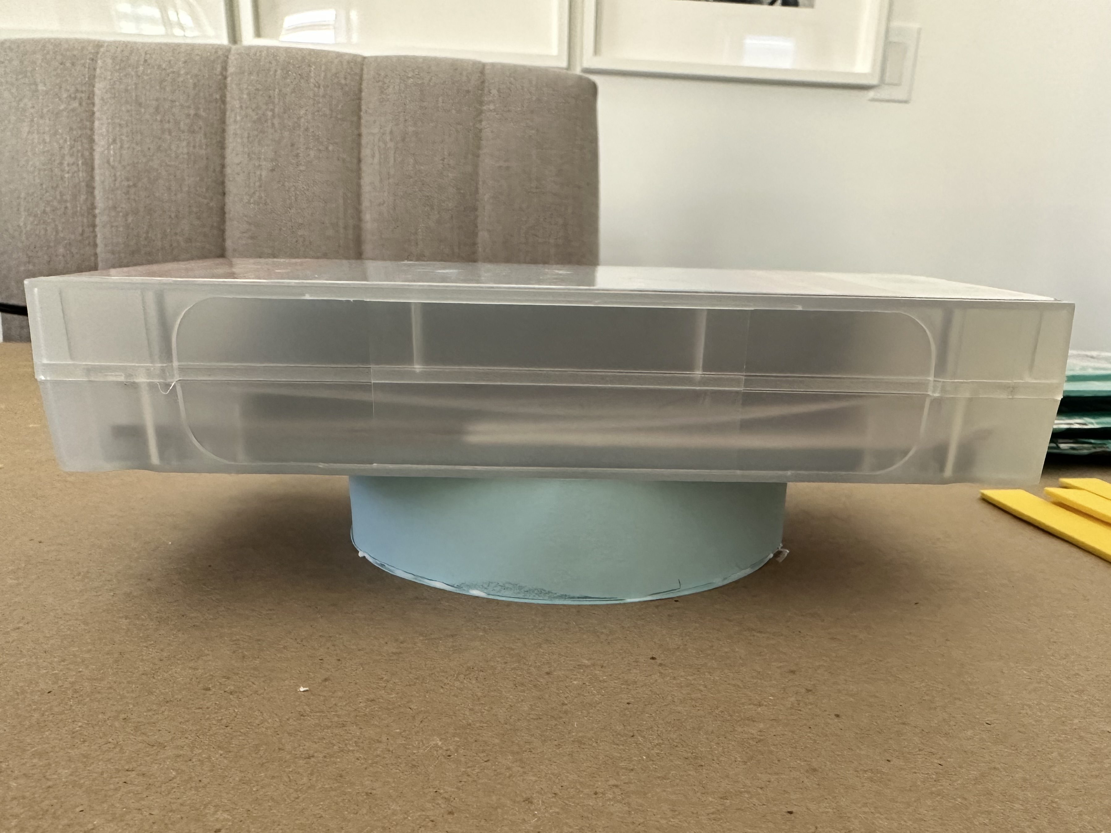 Weighted container placed on top of a blue cardstock hat piece while the glue dries.