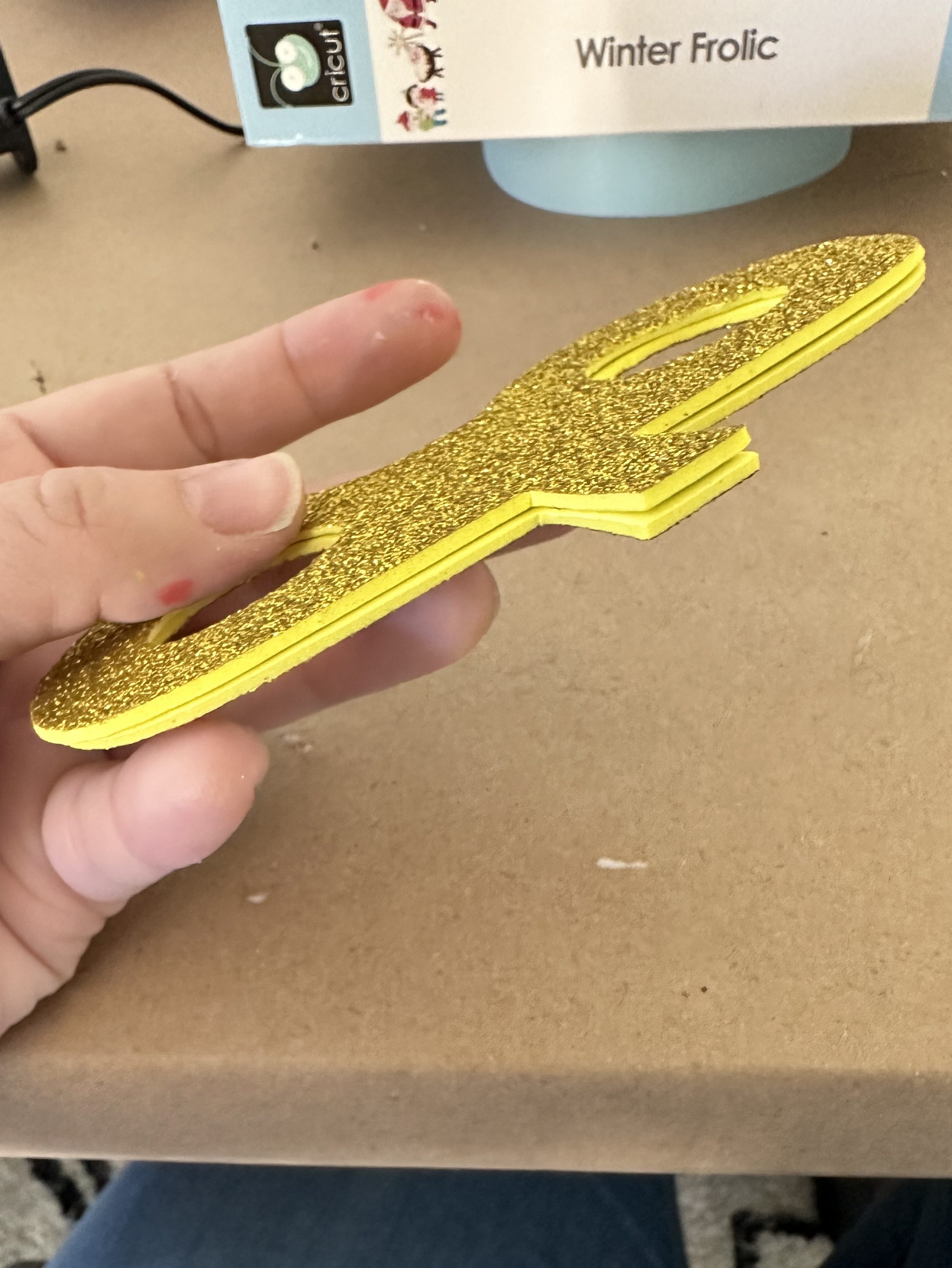 Gold glitter foam cut into winder shapes, glued together for the Bob-omb wind-up key.