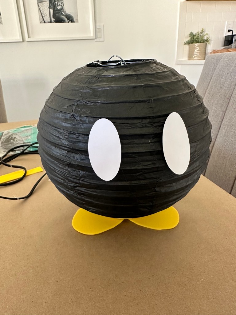 Bob-omb lantern with large white oval eyes glued to the front.