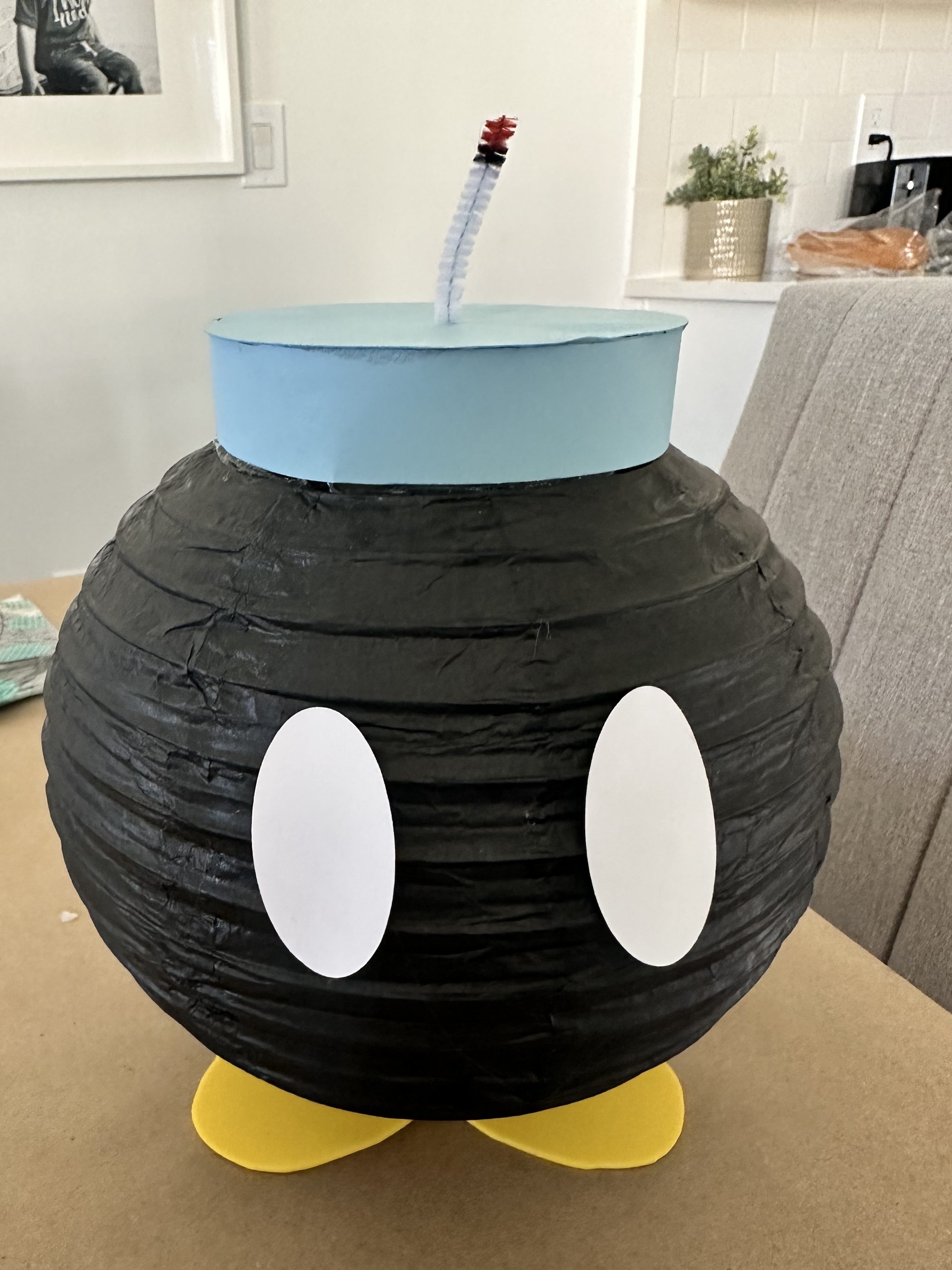 DIY Bob-omb with completed hat and fuse glued on top of the lantern body.
