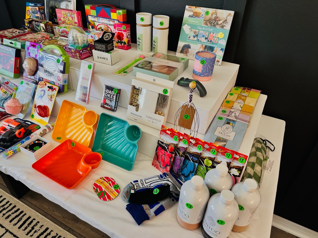 Close-up of adult-oriented prizes in Bubba’s Pizzeria gift shop including craft kits, candles, drink mixers, and socks.