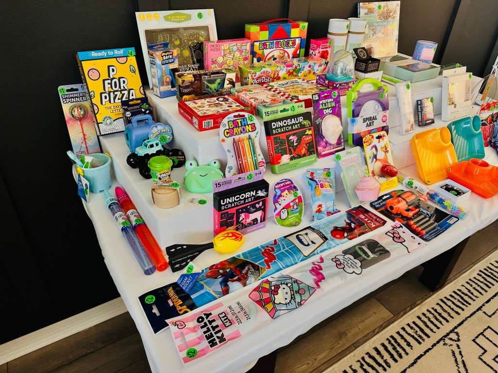 Close-up of children’s prizes in Bubba’s Pizzeria gift shop including toys, art supplies, and bubble wands.