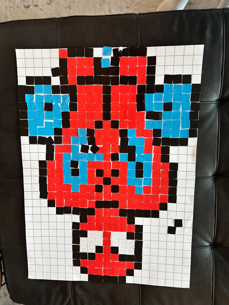 Completed Spider-Man mystery sticker mosaic poster created by party guests using square stickers.