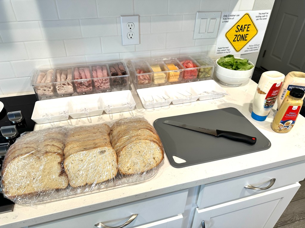 Build-your-own New York deli sandwich bar with fresh breads, meats, cheeses, toppings, and condiments.