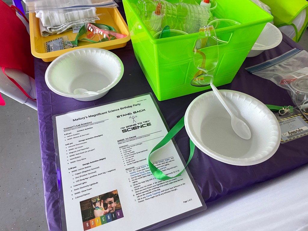 Science party lab schedule and recipes on table with bowls and spoons.