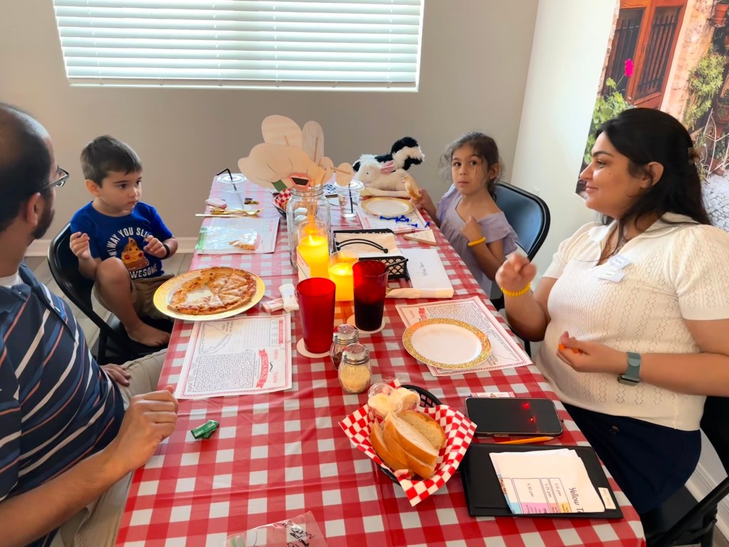 A team wrapping up their meal with nearly finished pizza and red cups at Bubba’s Pizzeria.