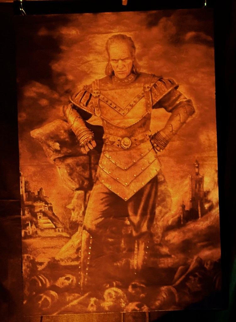 Ghostbusters II–inspired wall hanging of Vigo the Carpathian with a glowing, cinematic orange tint for Halloween ambiance.