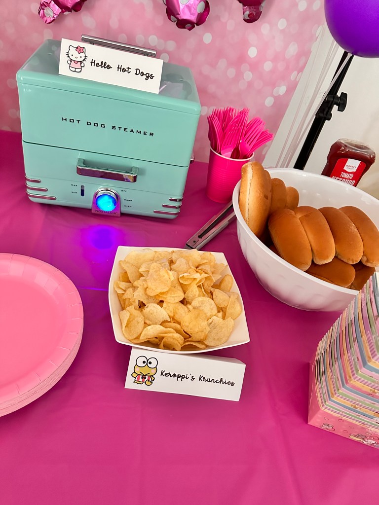 Hot dog steamer with buns and chips labeled as Hello Hot Dogs and Keroppi’s Krunchies.
