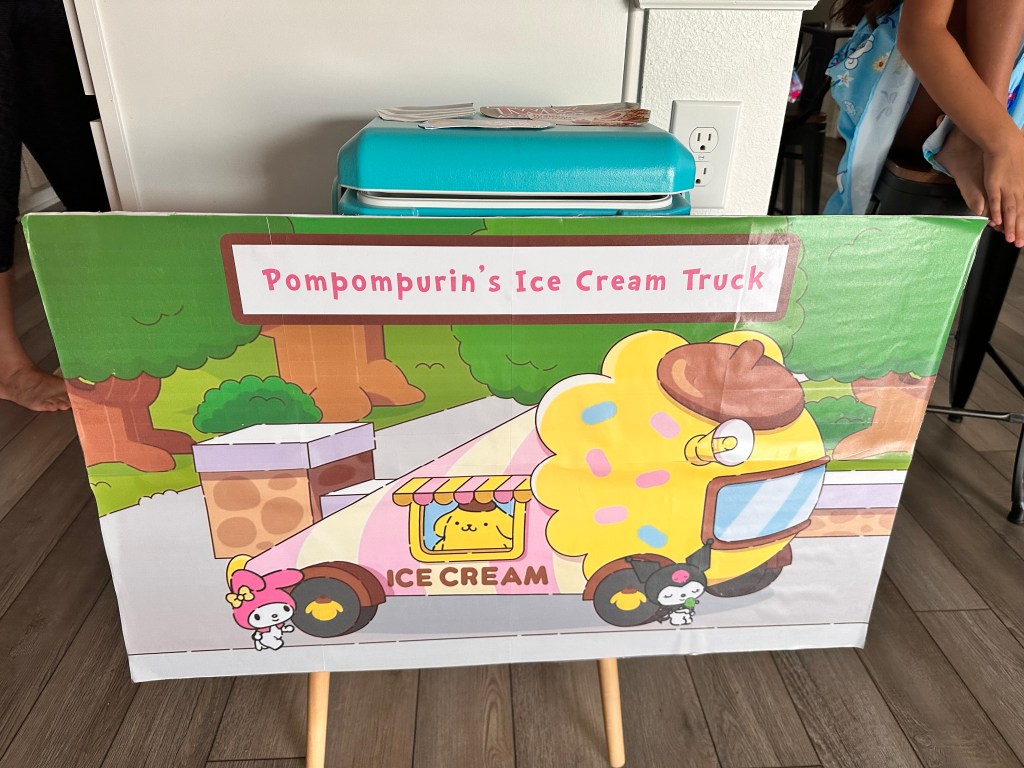Cooler decorated as Pompompurin’s Ice Cream Truck holding ice cream novelties